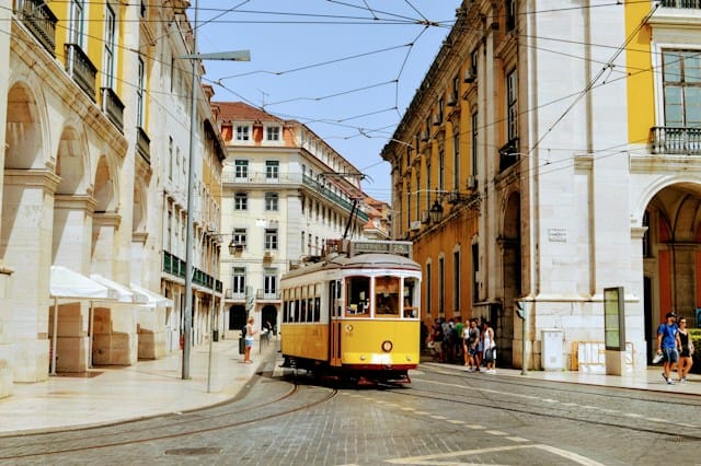 Lisbon, Portugal: yellow and white tram on road during daytime