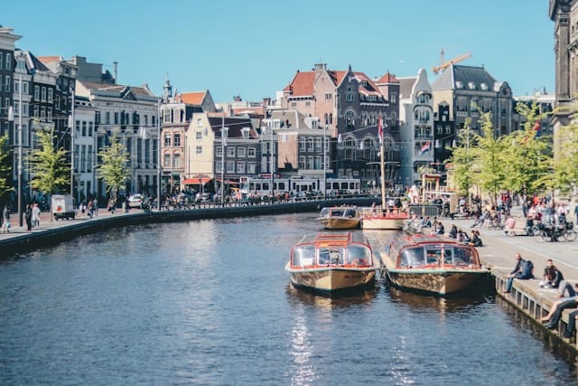 Amsterdam, Netherlands boats on the river near the buildings 