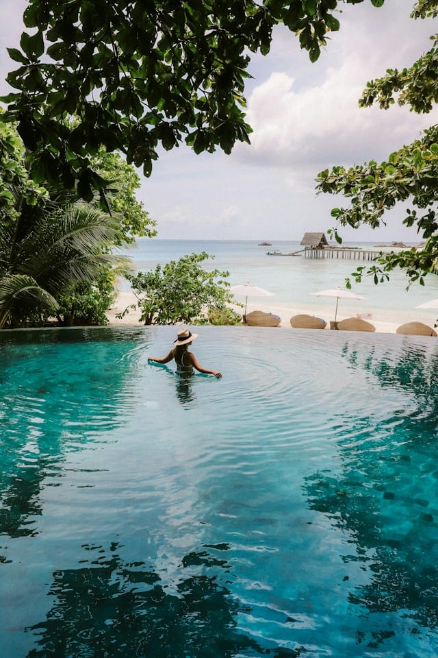 Woman on body of water during day time in Malives, one of the best places to travel in April.