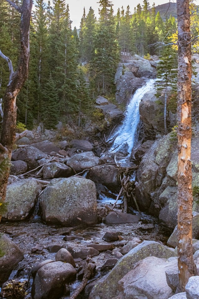 Rocky Mountain Adventure Colorado (USA) a small waterfall in the middle of a forest magic place fo summer camp